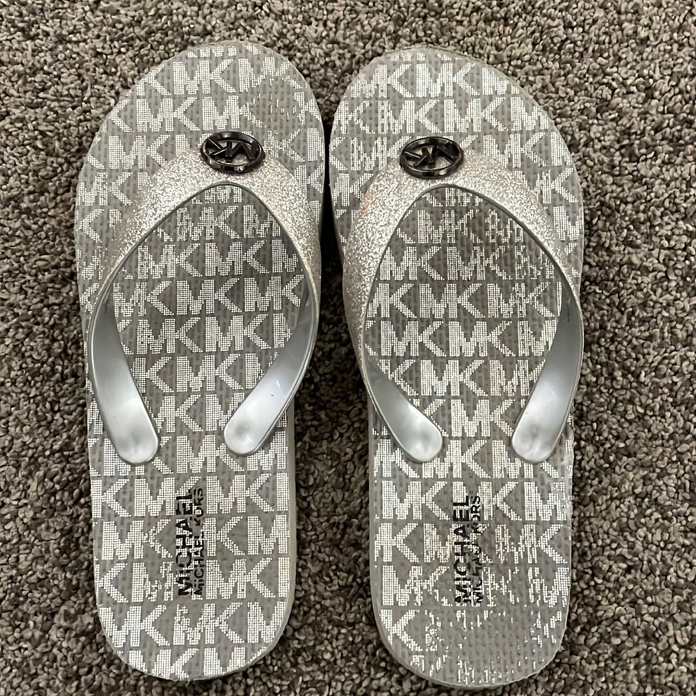 Gently used girls size 13/1 silver glitter MK flip flops soooo cute!
